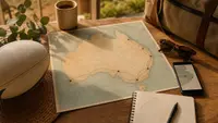 Australia host city travel planning with a map, route lines, luggage and a rugby ball