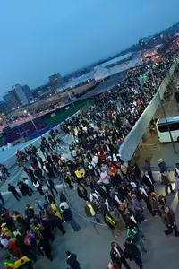 Fans gathering around a stadium before a match
